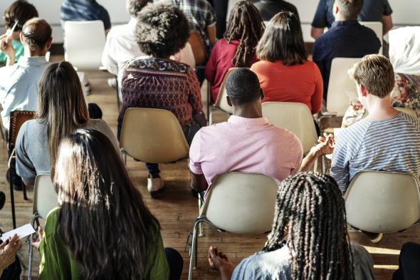 cheerful people sitting in meeting